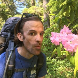Sasha and beautiful pink flowers in the woods