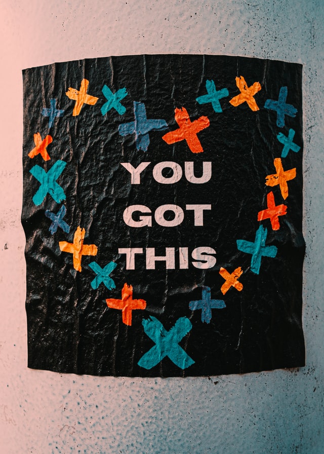 poster reading 'you got this' surrounded a heart-shaped outline composed of multicolored crosses